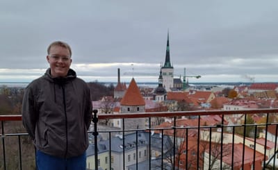 Me standing in front of a view of Tallinn's historic old town.